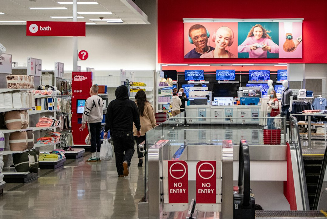 Busy retail store aisle crowded with customers during a seasonal sale